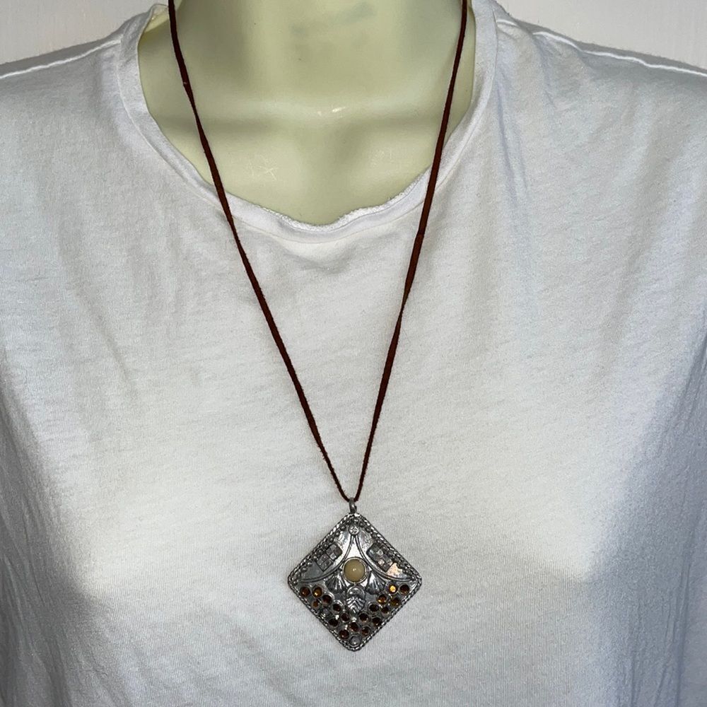 Silver tone square pendant with amber rhinestones on leather chain